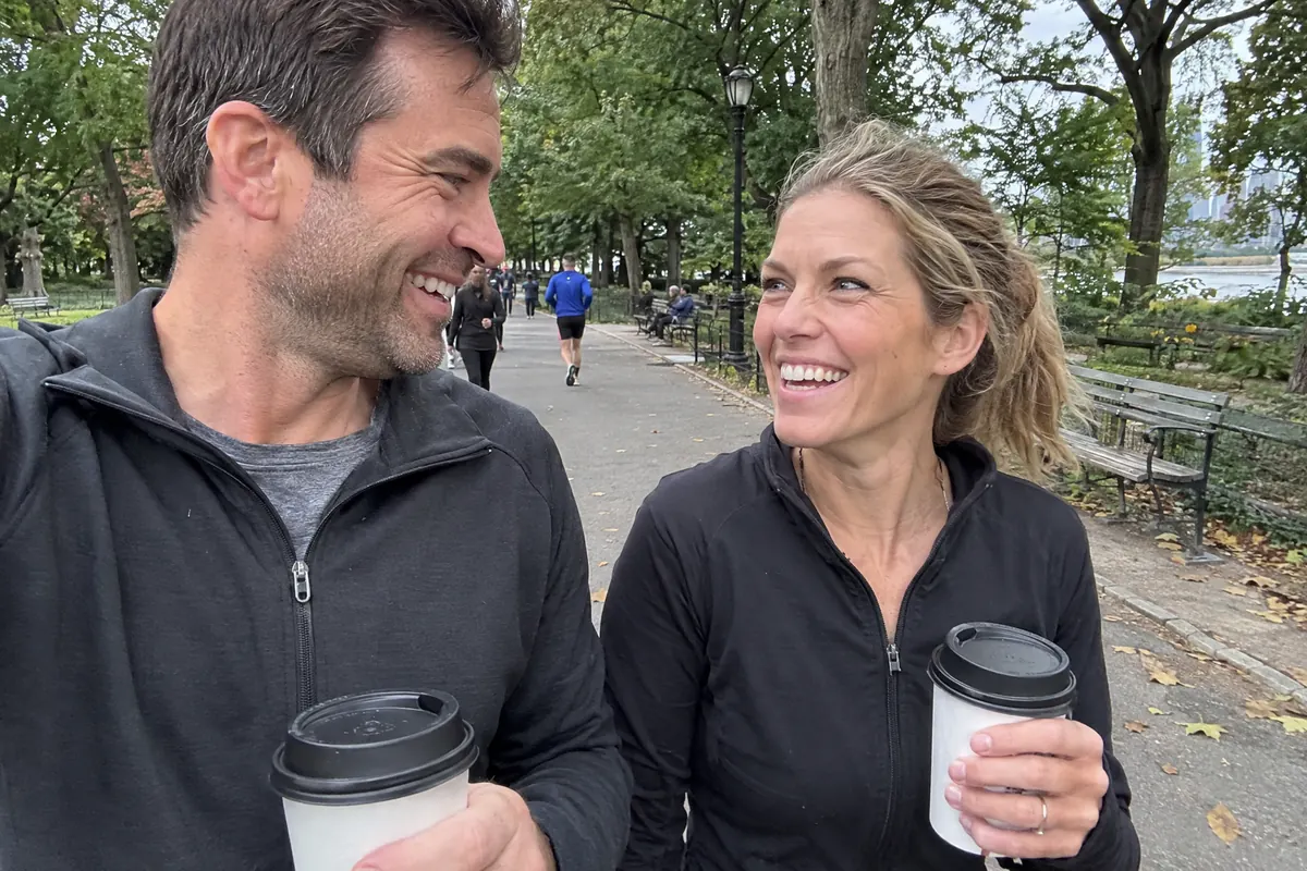 A fit couple laughing on a morning walk